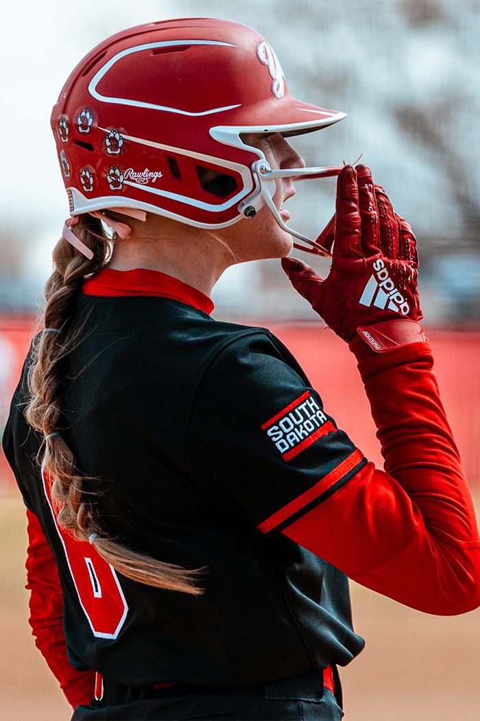 student-athletes in a group cheering with hands up