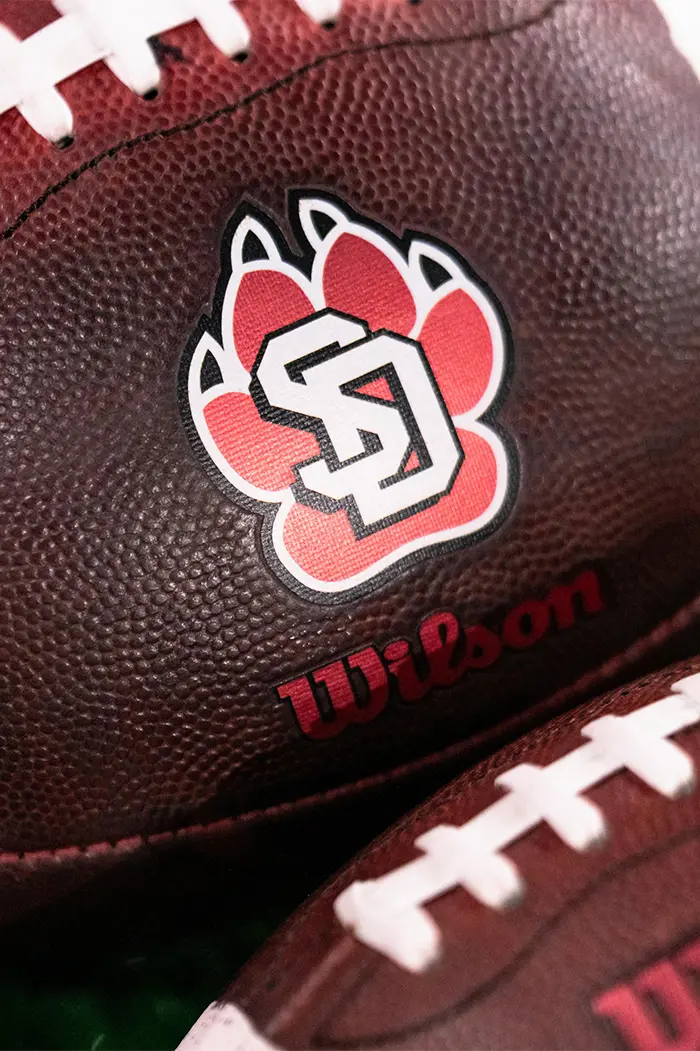 student-athletes in a group cheering