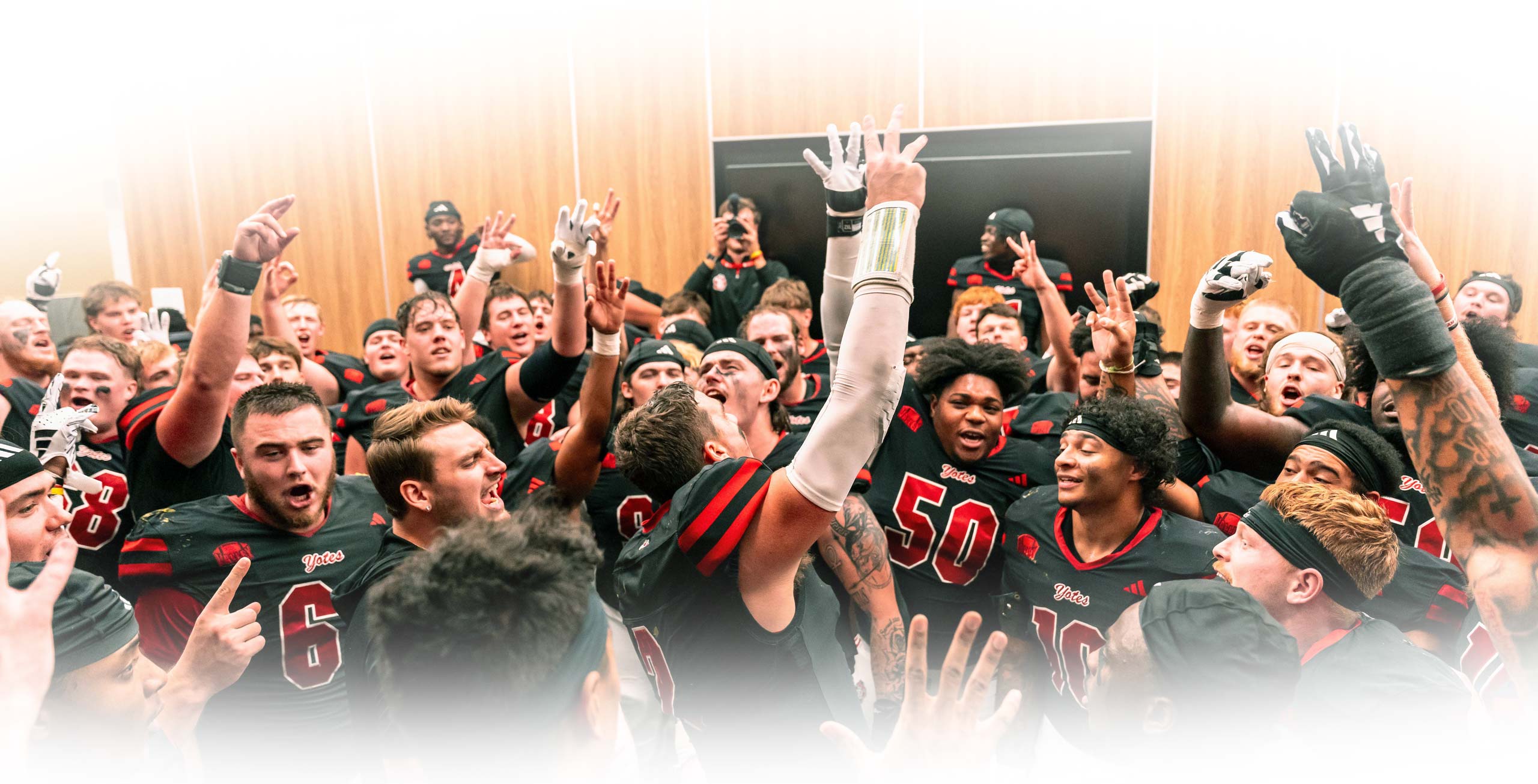 football players celebrating in the locker room